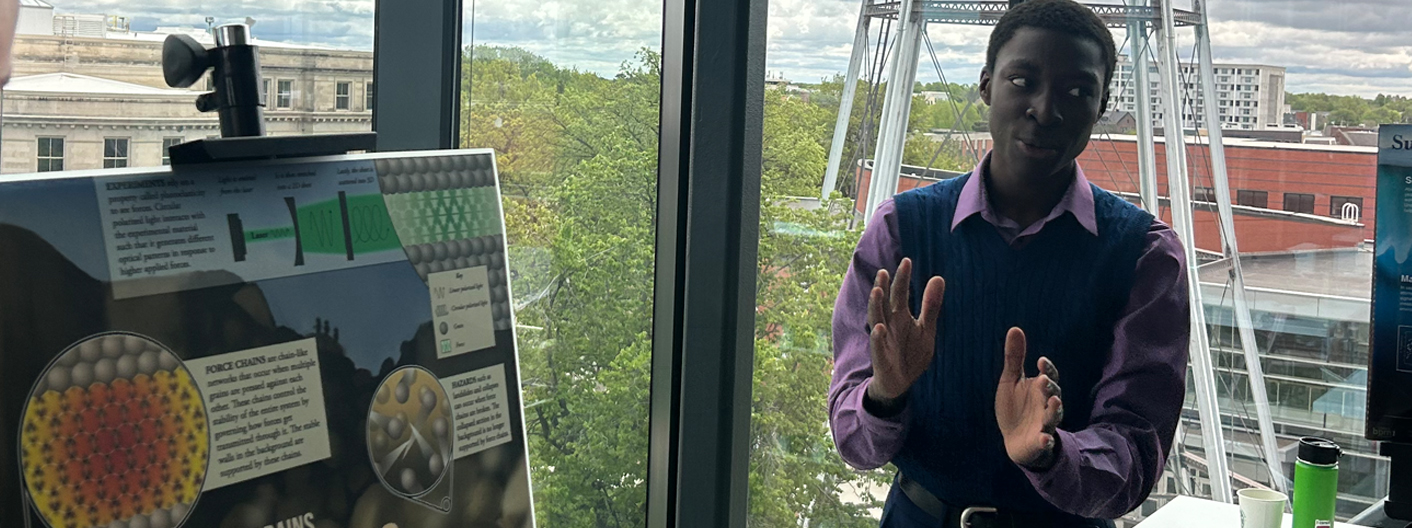 Student giving a poster presentation in the Student Innovation Center