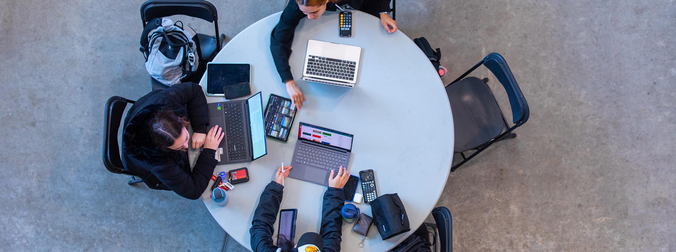 group of students studying around a table